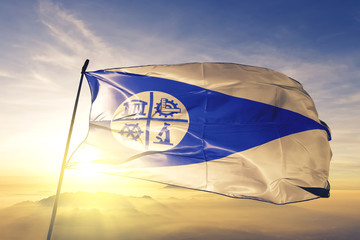 Minneapolis city of United States flag waving on the top sunrise mist fog