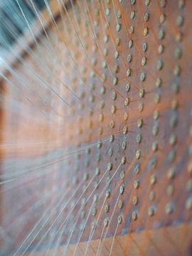 White and orange threads on loom