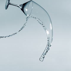 Beautiful splash of liquid from a martini glass on a white background.