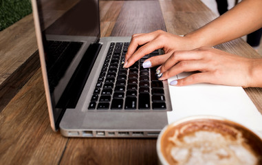 Fototapeta na wymiar Woman using laptop and searching web