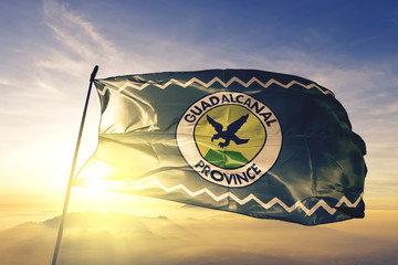 Guadalcanal province of Solomon Islands flag waving on the top sunrise mist fog