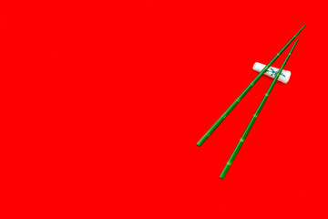 asian cuisine set with bamboo sticks for sushi and maki on red background top view mock up