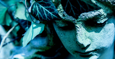 Beautiful angel marble sculpture with a sweet expression that looks down (religion, faith, Christianity concept)