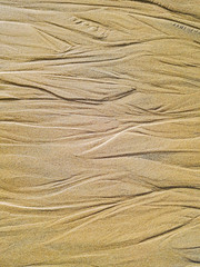 The bed of the brook flowing into the sea on a sandy beach. Italy, Sicily, 12.19.2018