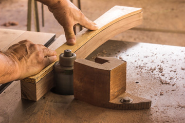 carpenter cutting wood with saw