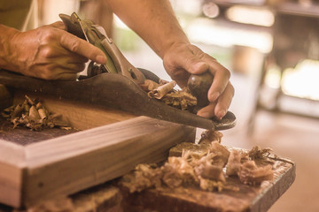 carpenter cutting wood with saw