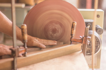 carpenter cutting wood with circular saw