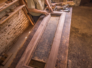 worker cutting wood with circular saw