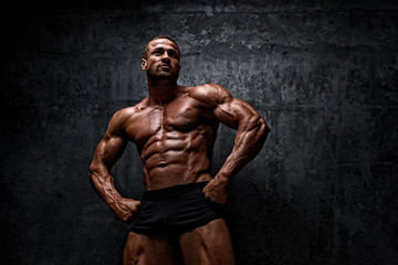 Fototapeta na wymiar Power! Strong Muscular Men posing and Flexing Muscles