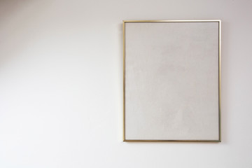 Blank painting on white wall with golden frame, space for text