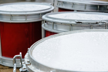 Band drums abandonded in the rain