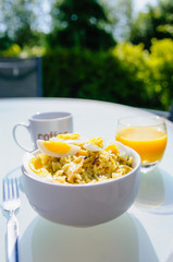 Al fresco breakfast with kedgeree, coffee and orange juice in a sunny garden