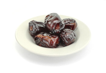 Dried dates over white background. Heap of dried dates isolated on white background.