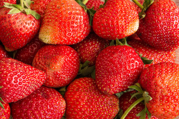 Stack of red strawberries closeup for background.
