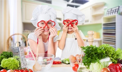 Portrait of adorable little girl and her mother cooking together