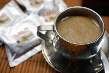 cup of coffee with sugar and spoon on wooden table