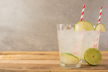 Summer cool drink, lemonade with lime and ice, two glasses with space, summer mood, refreshing drink, freshness