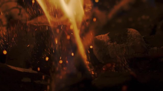 Stiring charcoal. Slow motion shot on Red camera