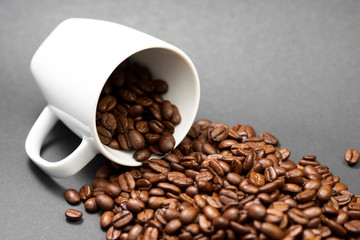 Freshly ground roasted coffee beans with fruits of coffee plant with a black background.
