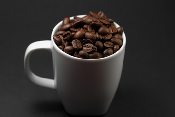 Freshly ground roasted coffee beans with fruits of coffee plant, full of grains.