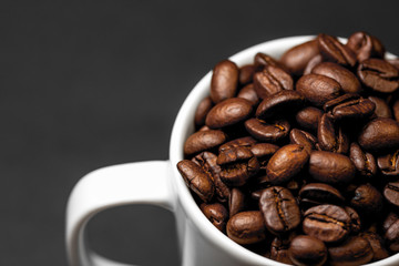 Freshly ground roasted coffee beans with fruits of coffee plant, full of grains.