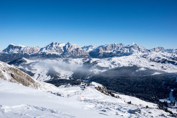 Fototapeta premium A ski slope above clouds, Alta Badia, Italy