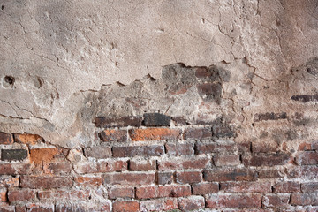 Background of old vintage dirty brick wall with peeling plaster, texture 