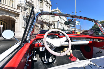 Interior of a red vintage car and view through the windshield, Havana, Cuba