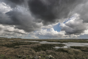Fototapeta na wymiar Storm clouds over the marshes on the English Kent coast.