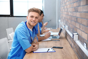 Naklejka na ściany i meble Medical student with groupmates studying in university