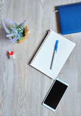blue Notepad, blank Notepad, pen and phone, top view