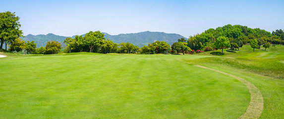 Fototapeta na wymiar Panorama View of Golf Course with beautiful green. Golf is a sport to play on the turf.