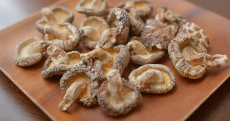 Stack of dry mushroom on wooden plate