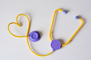 Medical stethoscope and heart on a white background