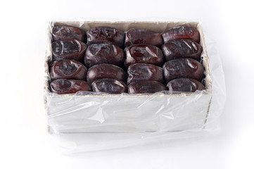 Large Medjool Dates in a cardboard packing. Closeup view of top