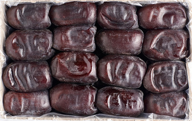 Large Medjool Dates in a cardboard packing. Closeup view of top