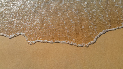 Soft wave of ocean on sandy beach