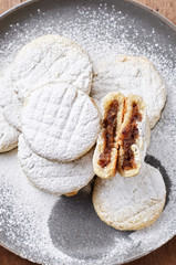 Arabic homemade cookies filled with dates and walnuts covered powdered sugar