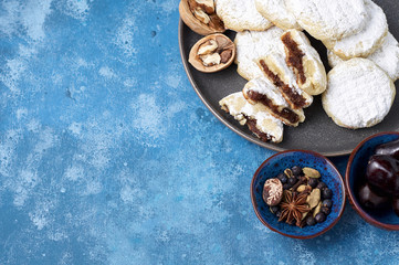 Arabic homemade cookies filled with dates and walnuts covered powdered sugar