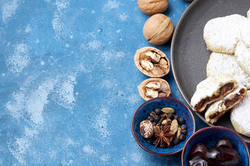 Arabic homemade cookies filled with dates and walnuts covered powdered sugar