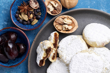 Arabic homemade cookies filled with dates and walnuts covered powdered sugar