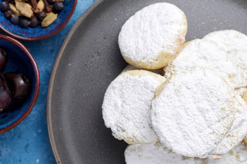 Arabic homemade cookies filled with dates and walnuts covered powdered sugar