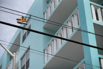 Sneakers shoes hanging from power lines