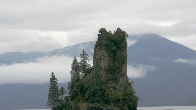 A wide angle shot of New Eddystone Rock in Alaska. The camera passes by showing the entirety of the isle.