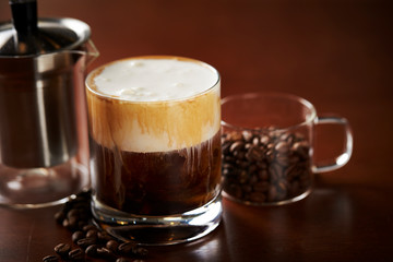 Coffee with cream and coffee beans 