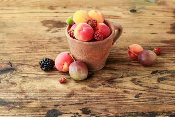 Vintage caramic mug full of colorful summer fruits
