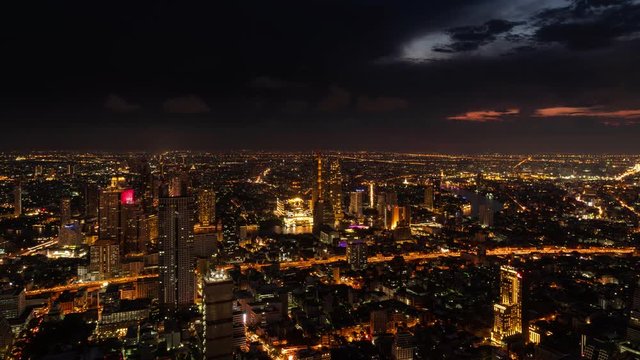 An aerial view of  Bangkok cityscape including Chao Phraya River during night time, 4k Time lapse