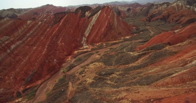 Aerial above view of colorful Danxia rock formations of The Zhangye National Geopark in Gansu province of China, 4k drone nature landscape footage