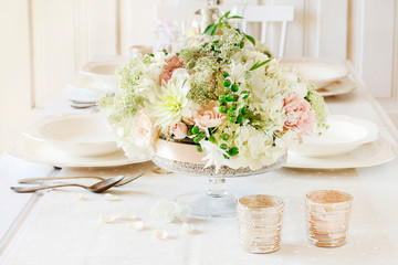 Floral decorations on summer party table,  romantic wedding reception.