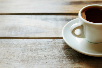Cup of coffee on brown wooden table